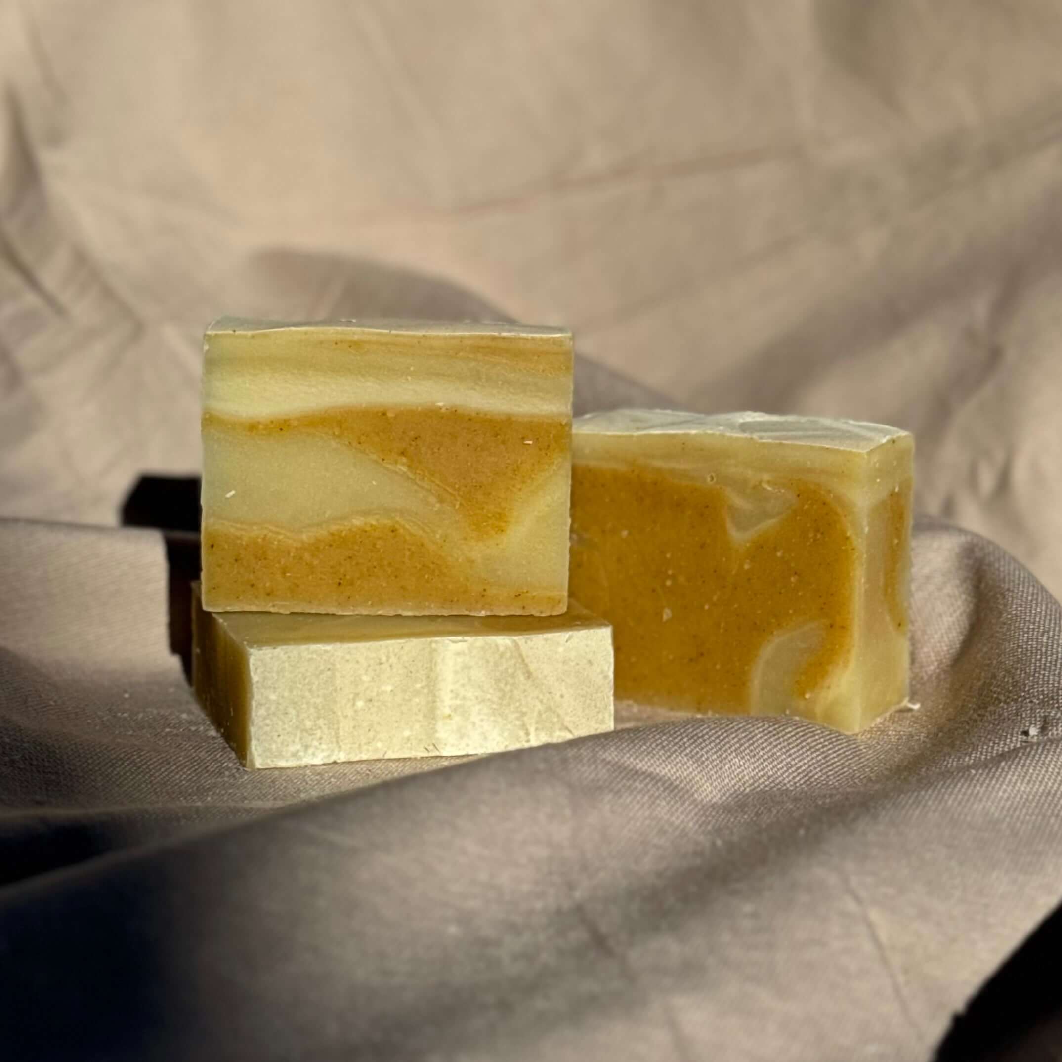 Alt Tag: Patchouli & Ylang Ylang Body Bar natural patchouli soap with turmeric on neutral fabric background