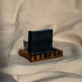 Detoxifying Charcoal Cleansing Bar displayed on wooden soap dish for deep pore cleansing and skin purification