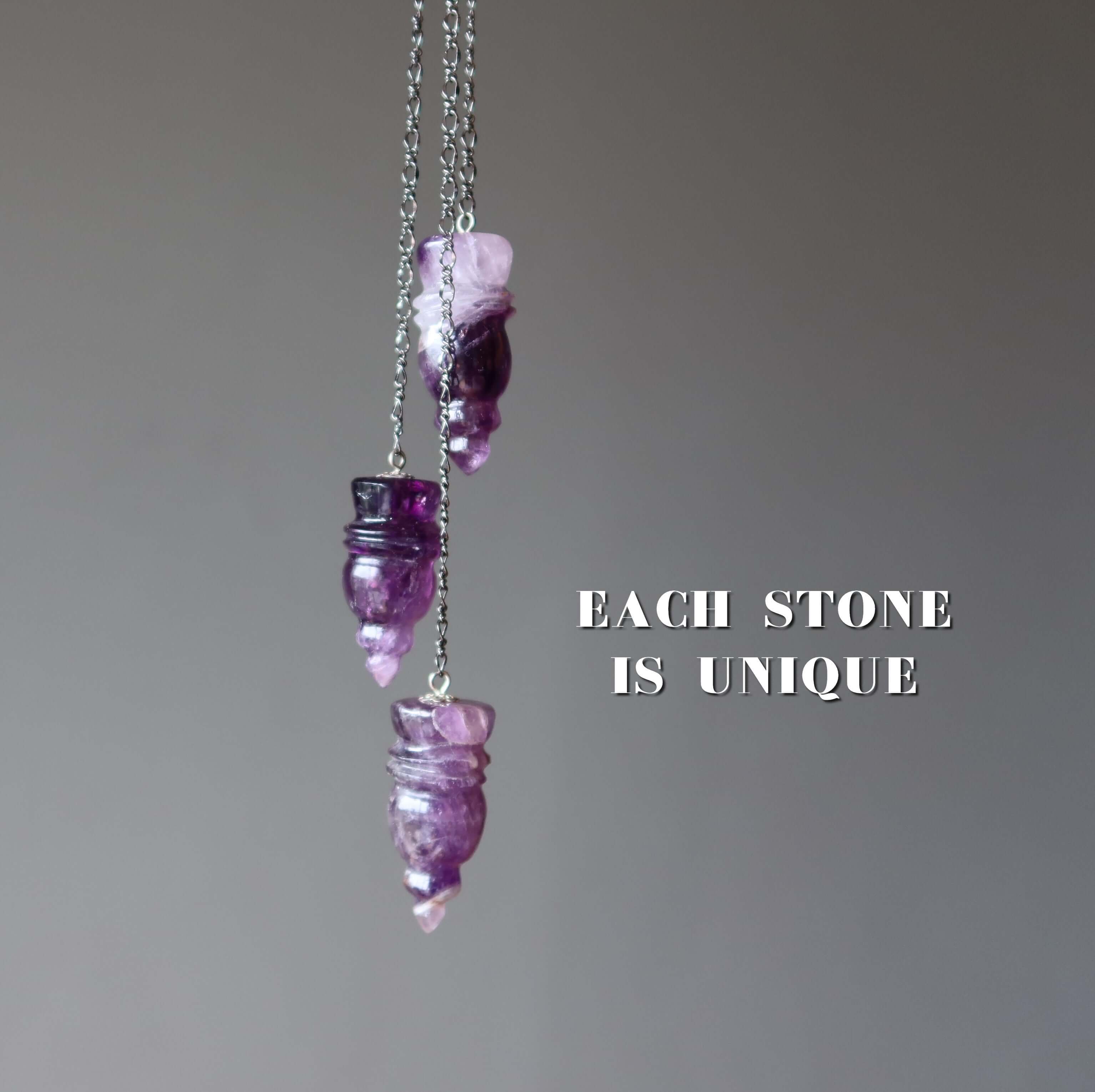Amethyst pendulum for dowsing featuring three carved purple crystal points on chains, each stone is unique