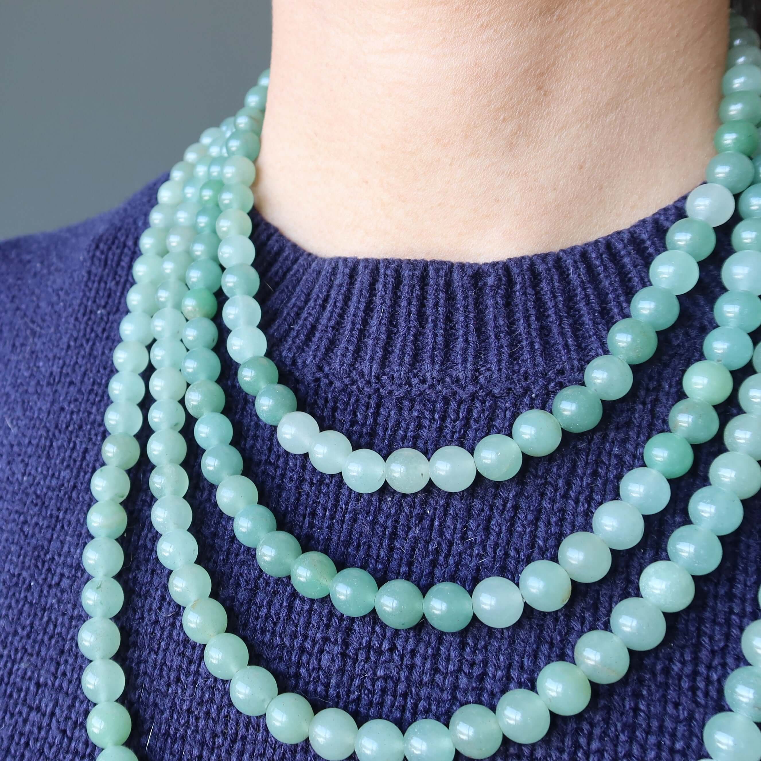 Green Aventurine necklace strands of 7-8mm wealth stones layered on neck, abundance crystal jewelry on blue sweater