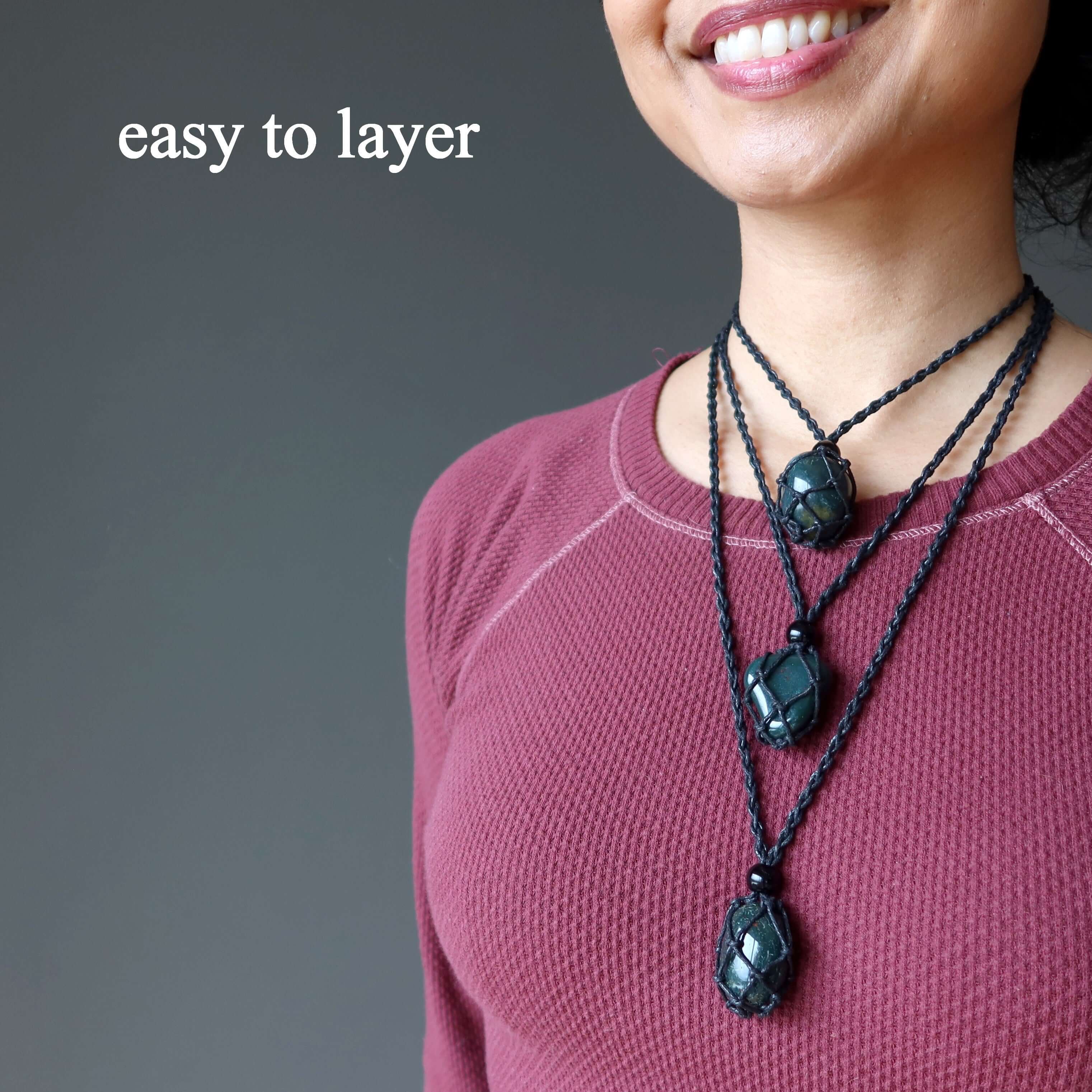 Layered Bloodstone necklace courage carrier macrame pendant set on adjustable black cords on model in mauve top
