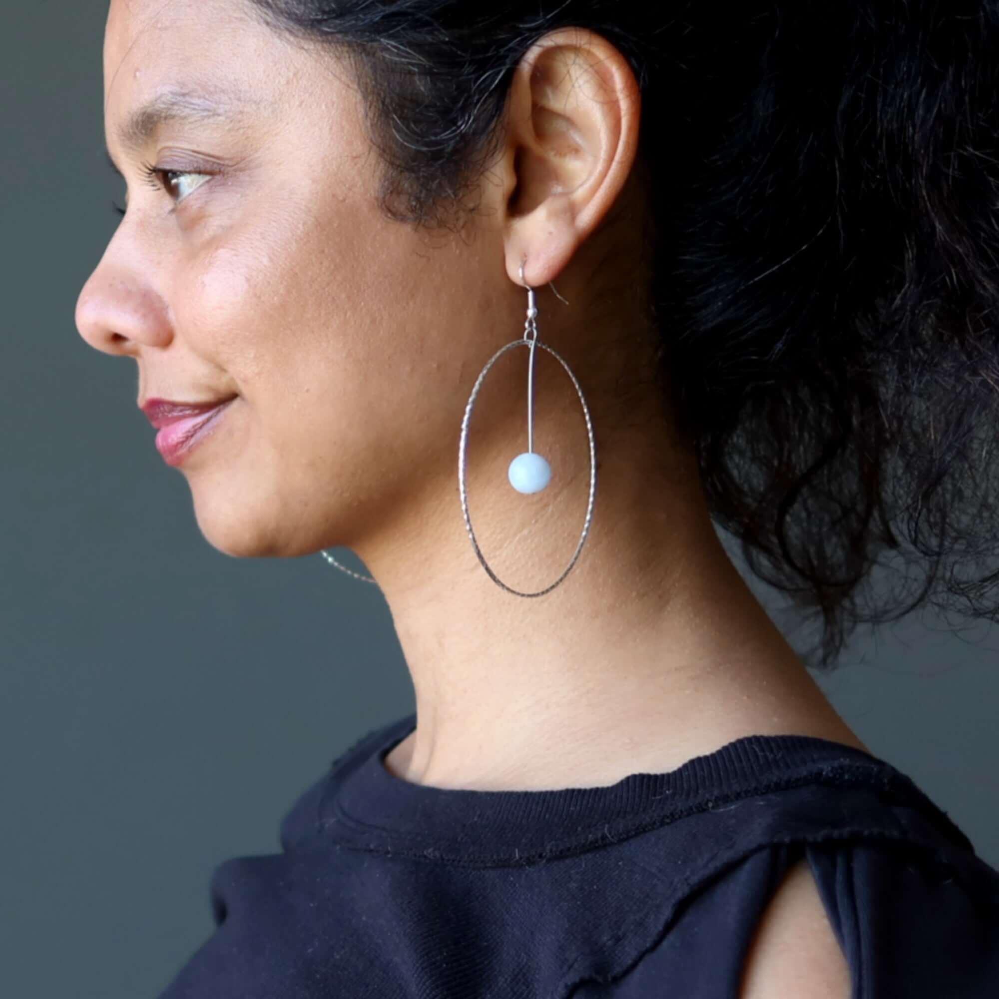 Blue Calcite earrings Heavenly Hoops of Silver on model, large oval silver hoop with Blue stone bead for spiritual style