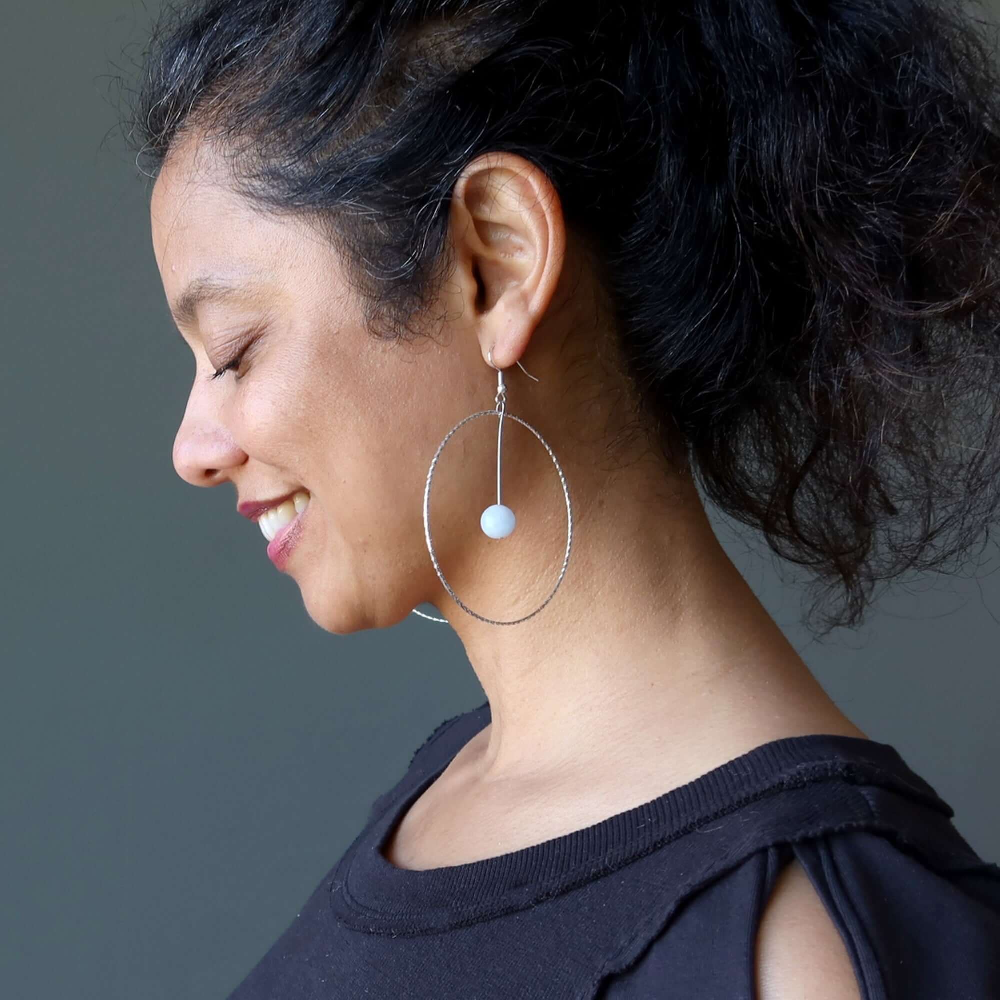 woman wearing large silver hoops with Blue calcite stone, side profile showcasing Blue Calcite earrings heavenly hoops of silver