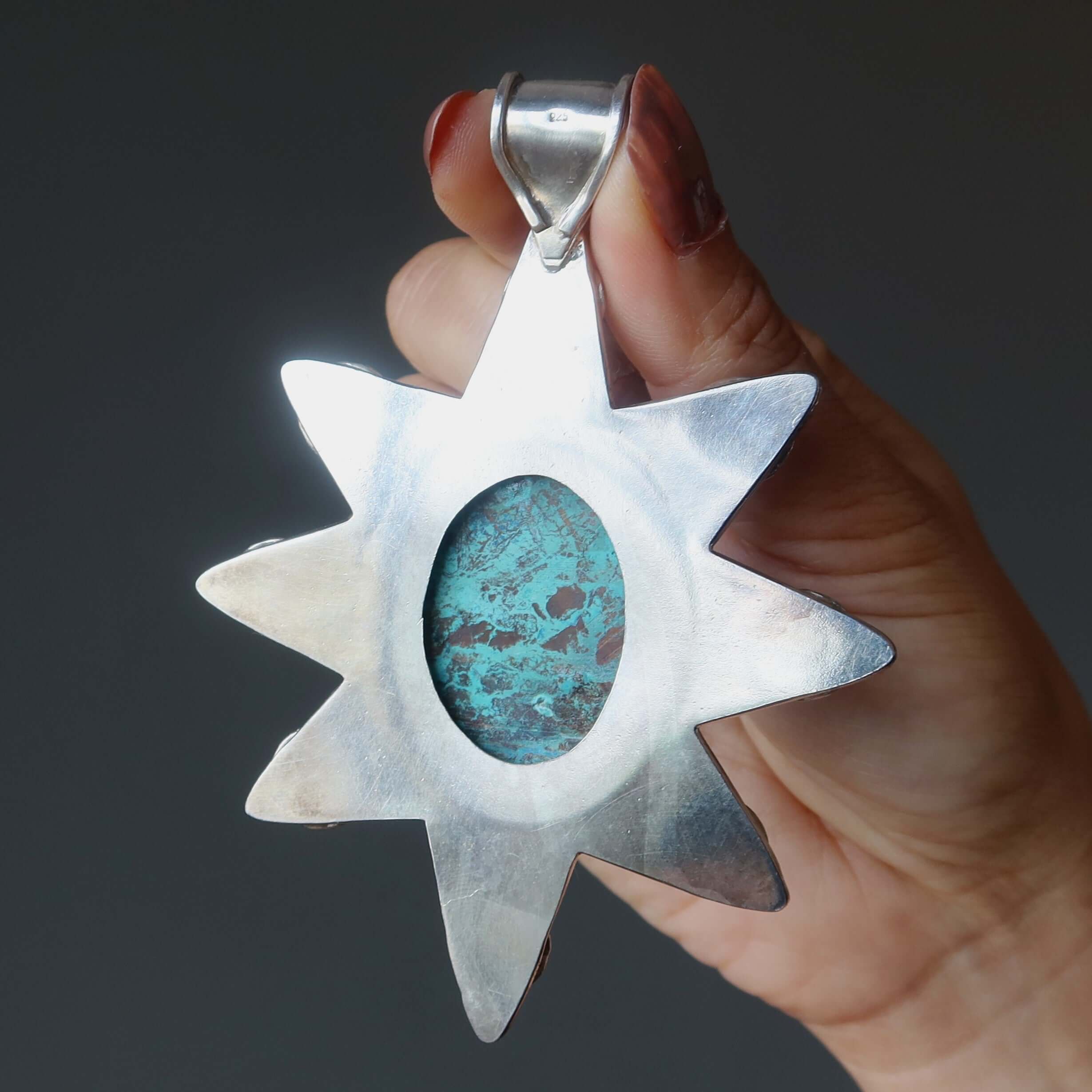 Chrysocolla sterling silver 8-pointed star pendant held in hand, showcasing large oval Chrysocolla gemstone