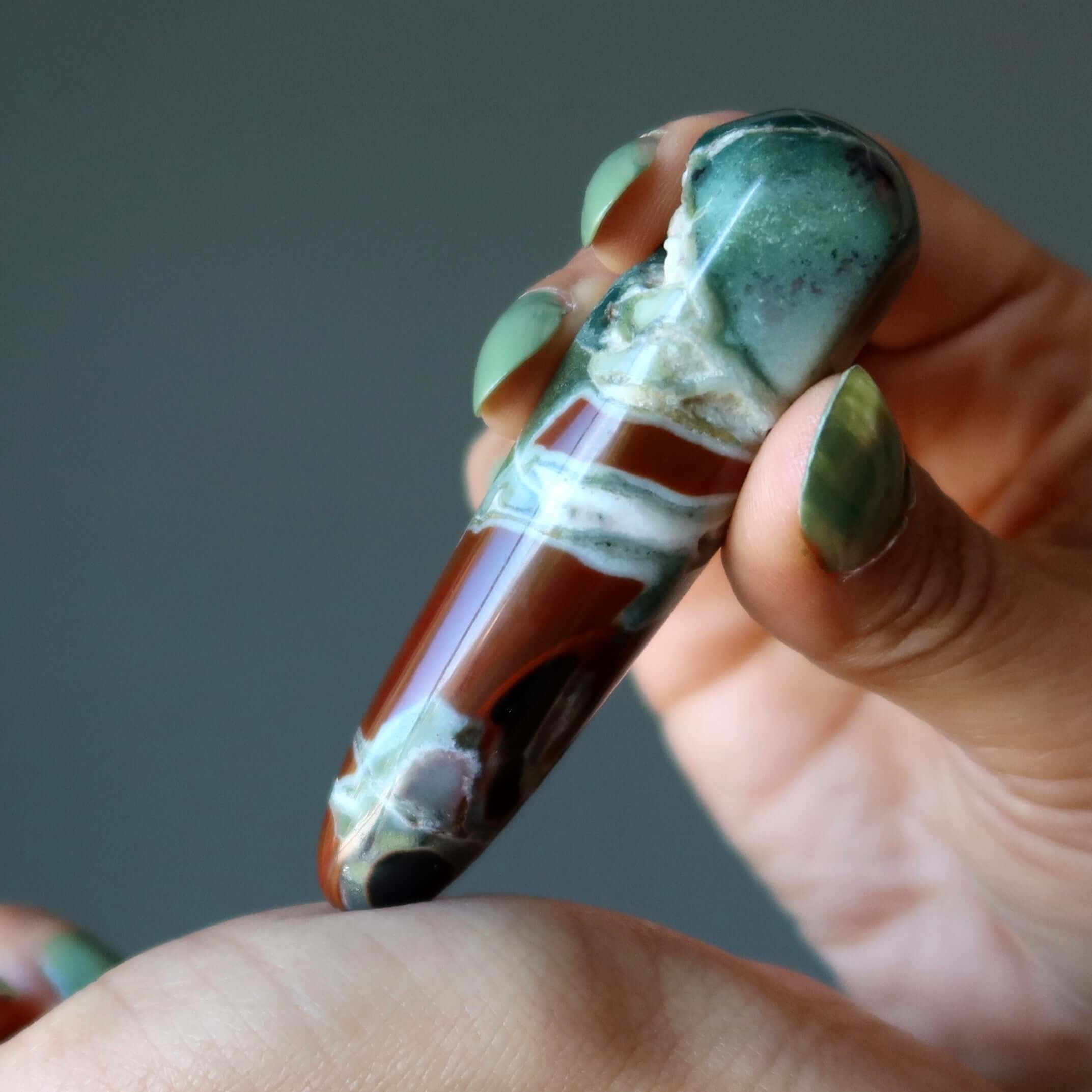 Jasper jasper massage wand earth energy stone held in hand for soothing crystal massage and stress relief