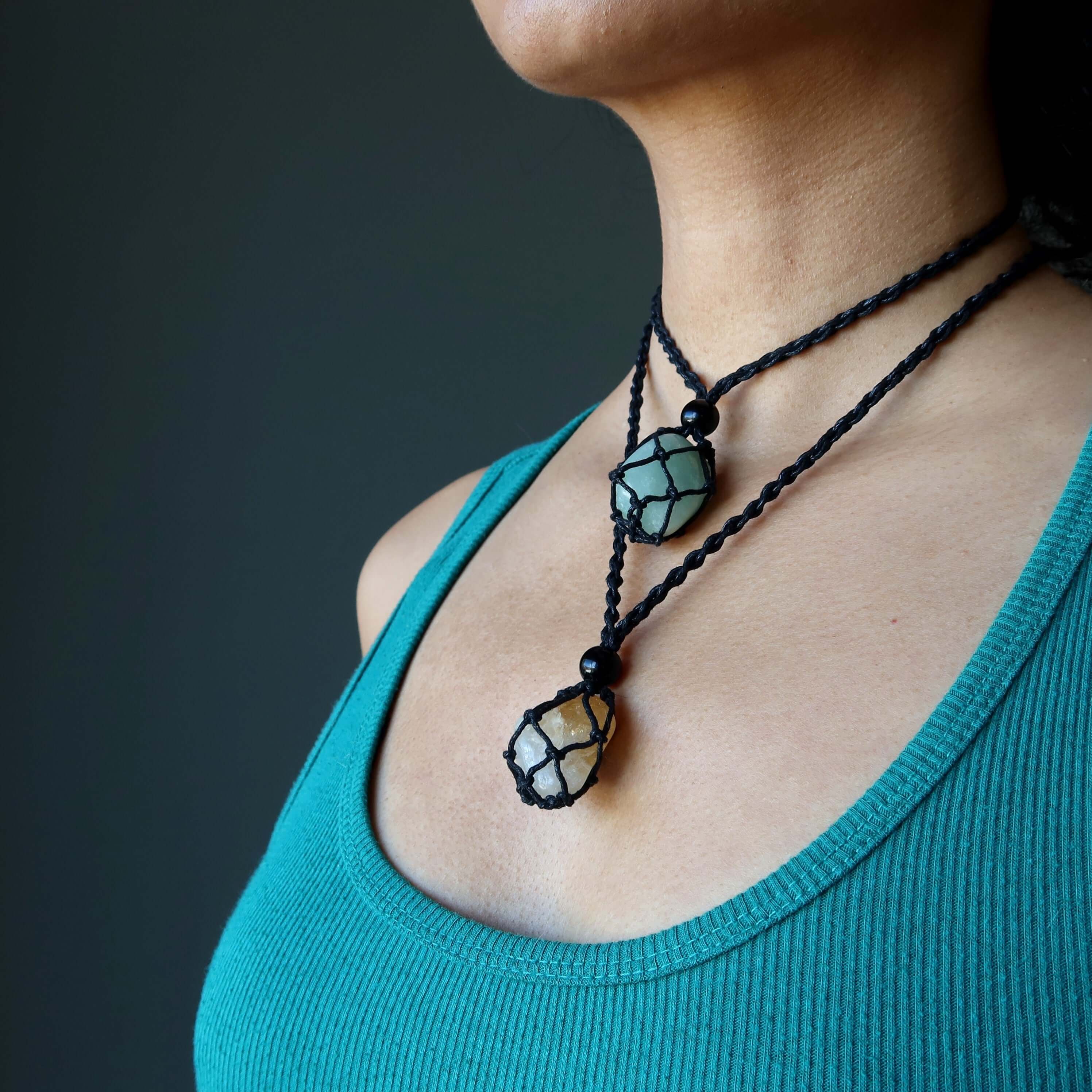 Money necklace set with citrine and green aventurine stones in black macrame cord on model’s neck