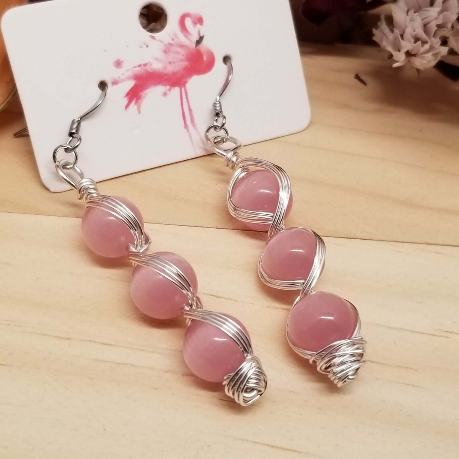 Handmade Pink Cat’s Eye Bead Earrings – Wire Wrapped Dangle Jewelry with stacked pink beads on silver hooks displayed on card