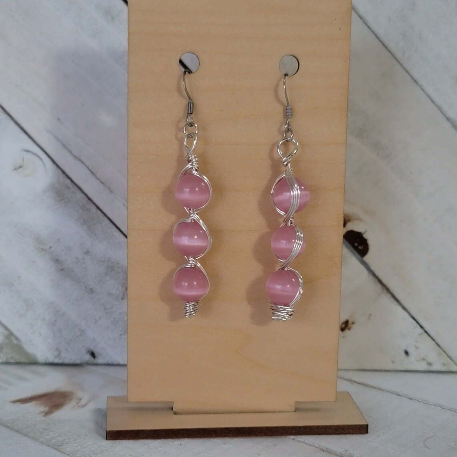 Handmade Pink Cat’s Eye Bead Earrings – Wire Wrapped Dangle Jewelry with stacked pink beads on hooks against display card