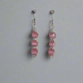 Alt Tag: Handmade Pink Cat’s Eye Bead Earrings – Wire Wrapped Dangle Jewelry with three stacked pink beads on silver-tone hooks