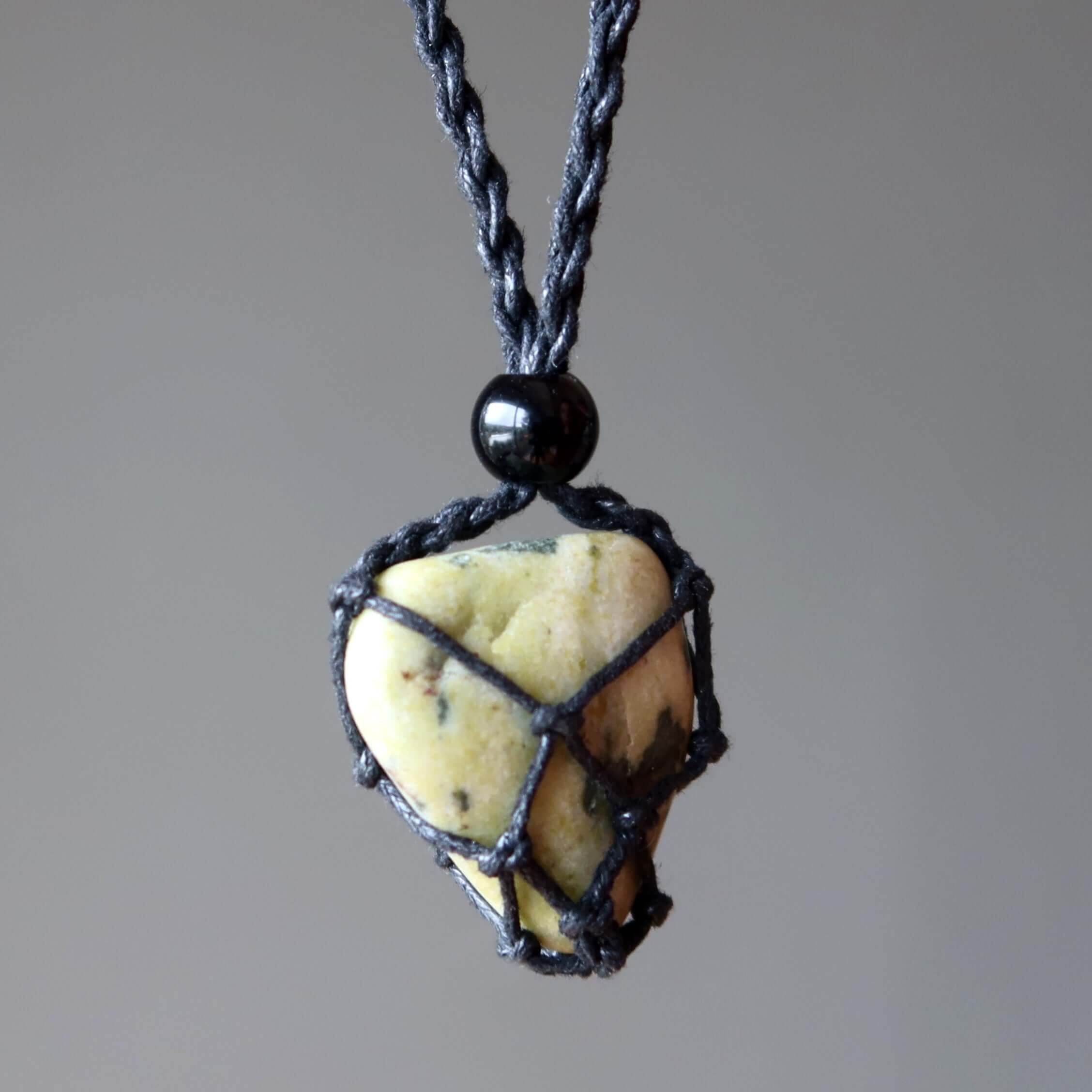 Serpentine necklace transformation stone in black macrame net on adjustable cord, healing crystal jewelry close up